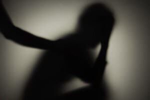 Unrecognizable sad woman and man in silhouette.  Relationship problems concept.